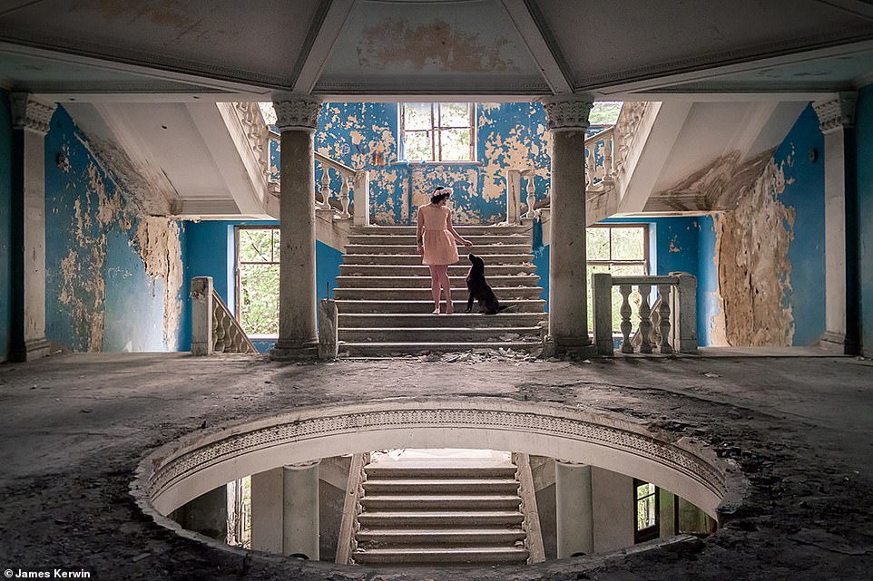 Jade pets a stray dog  inside an empty former sanatorium in Georgia. The animal had approached them during the shoot
