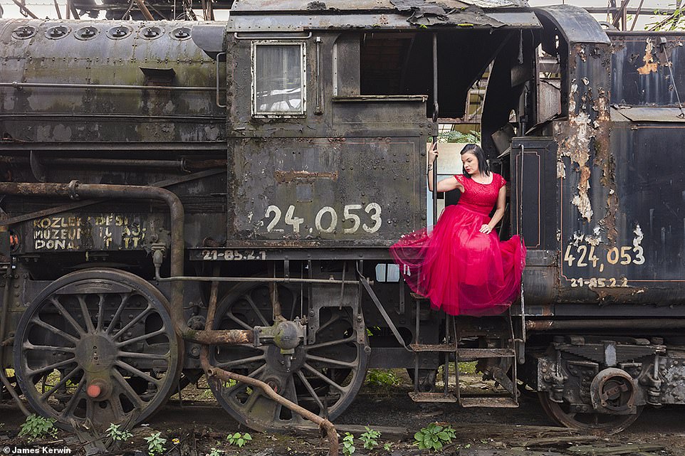 While the pair were in Hungary, they came across an abandoned Soviet railway train to pose against 