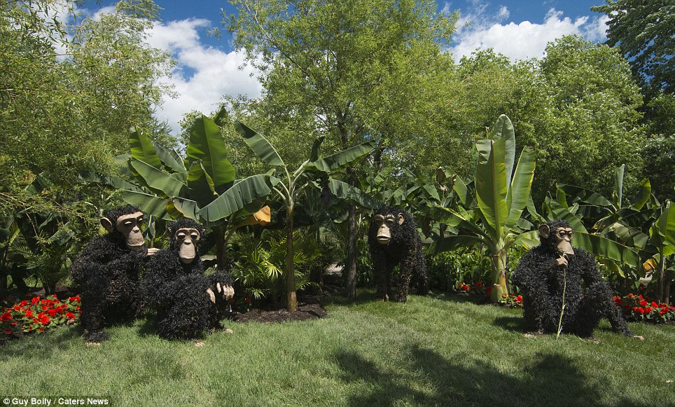 A family of monkeys is seen gathered on one mound where the artist has also brought in giant leaves to recreate the animals